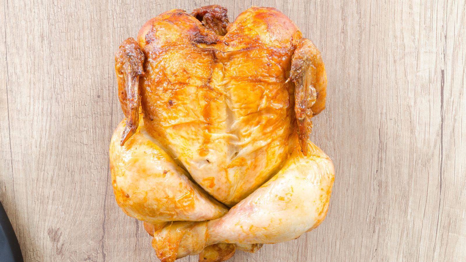 how to cook chicken in the slow cooker. image of slow cooked chicken on a beige background