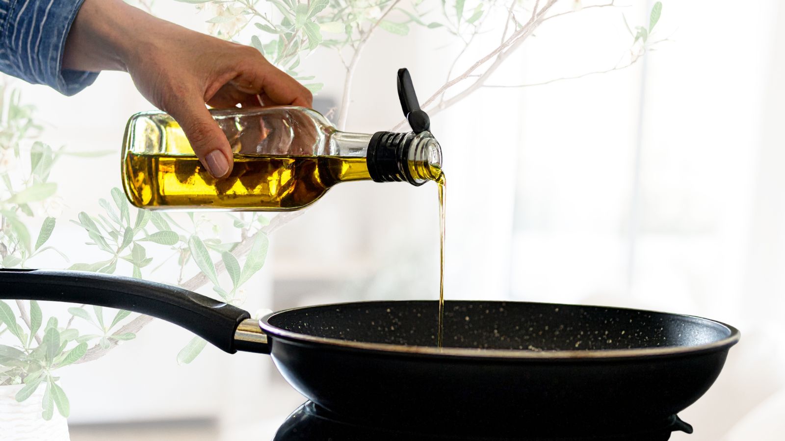 broccoli and king prawn risotto image of hand pouring olive oil into a frying pan