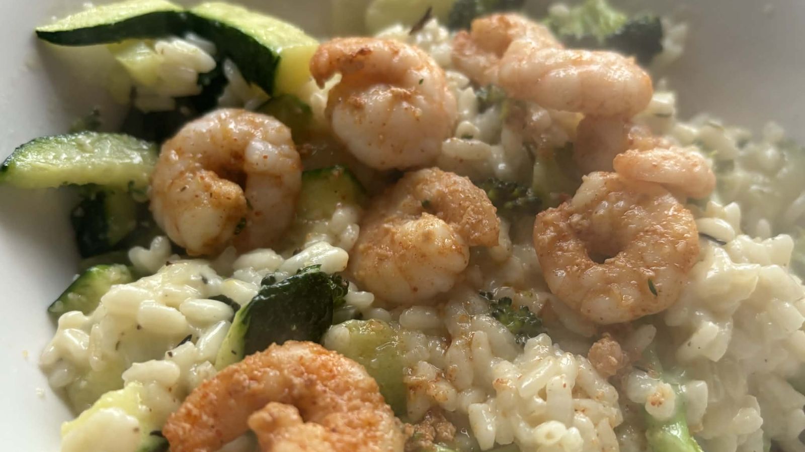 image of broccoli and king prawn risotto on a white background to illustrate broccoli and king prawn risotto