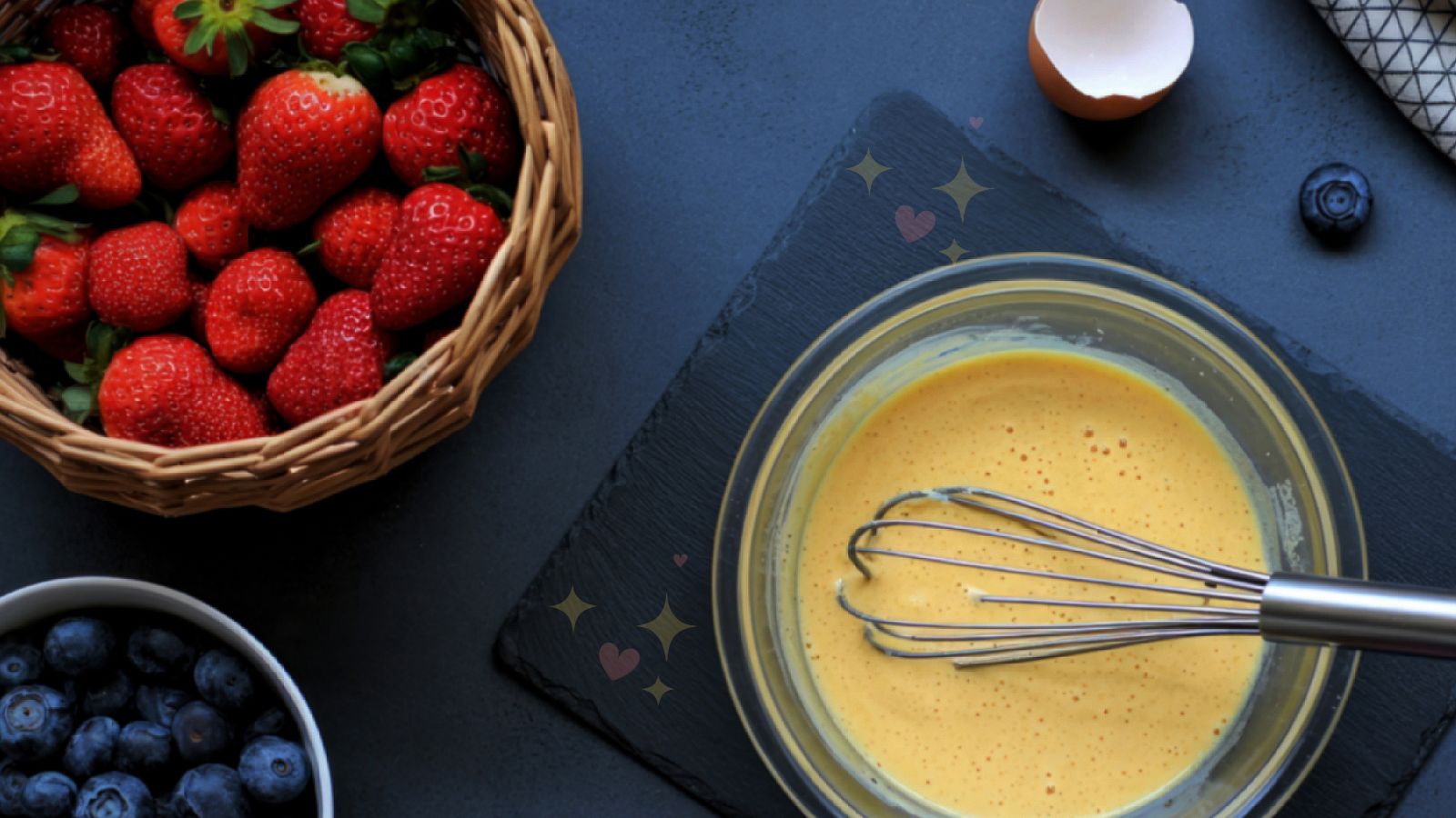 image of American pancake recipe batter and toppings including strawberries and blueberries on a greyish background