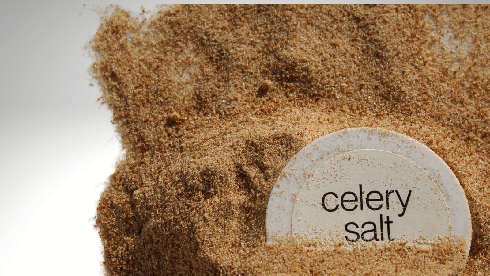 celery salt image of celery salt on a grey background with a label saying celery salt