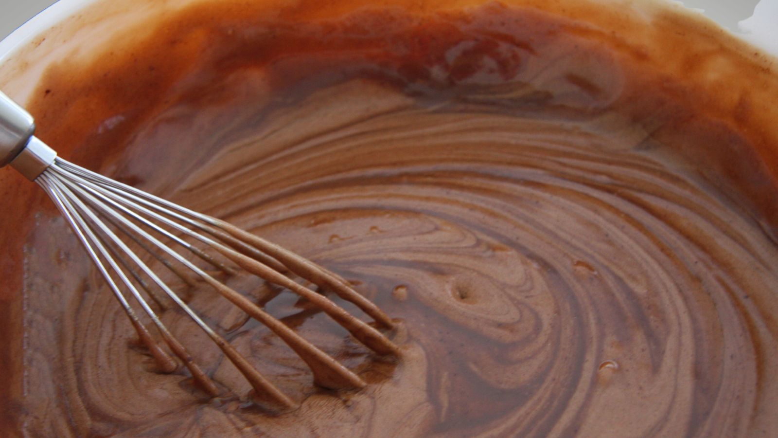 Never buy packet cake mix image of a bowl of chocolate cake mix and a whisk