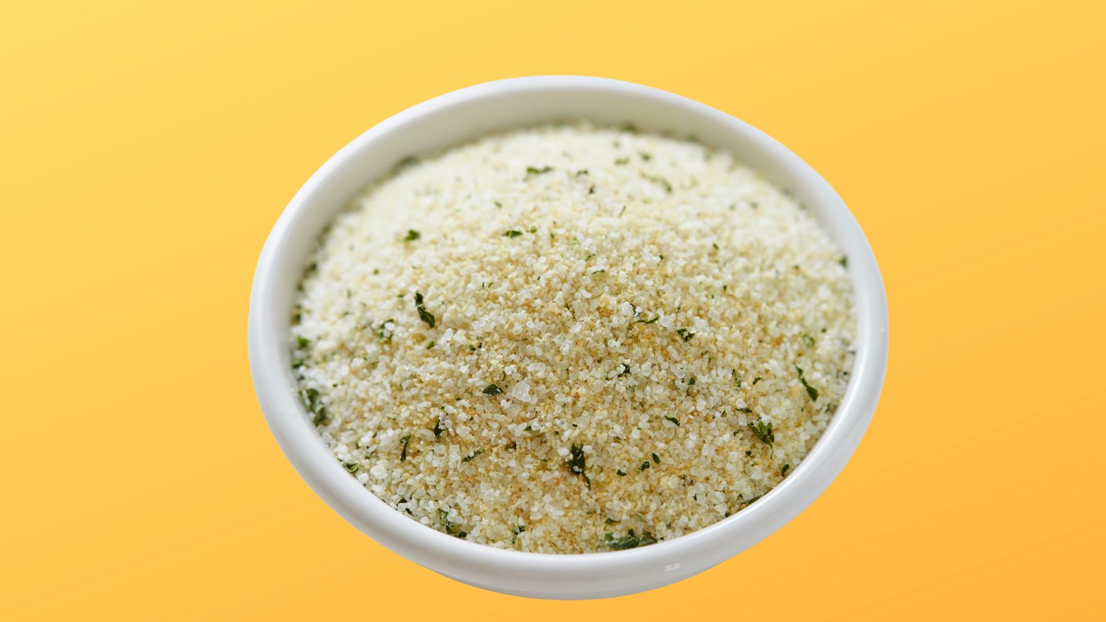 spice rack image of a bowl of garlic salt on a bright yellow background