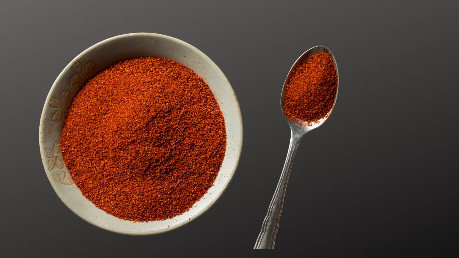 spice rack essentials paprika image of  dish of paprika and a spoonful of paprika on the side